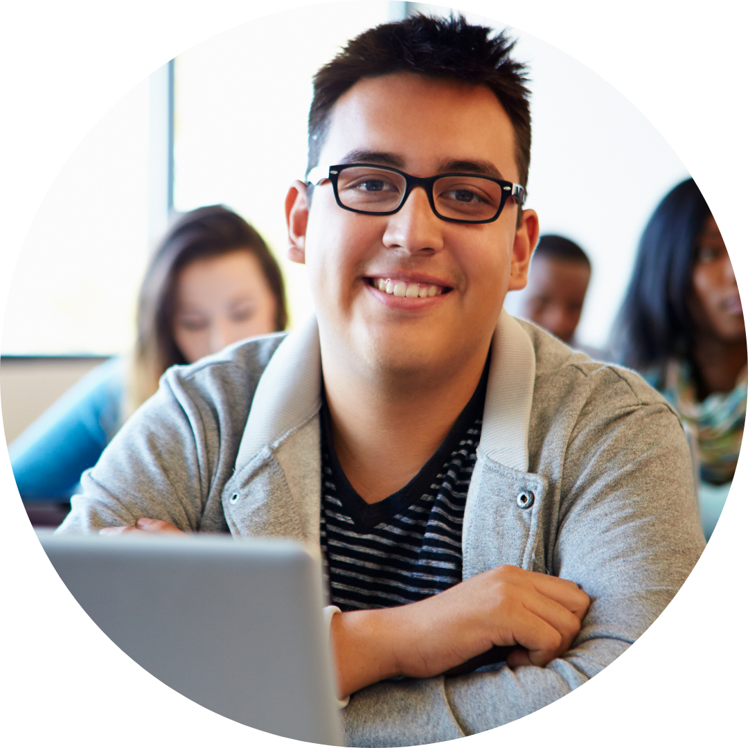 teen boy seated at laptop